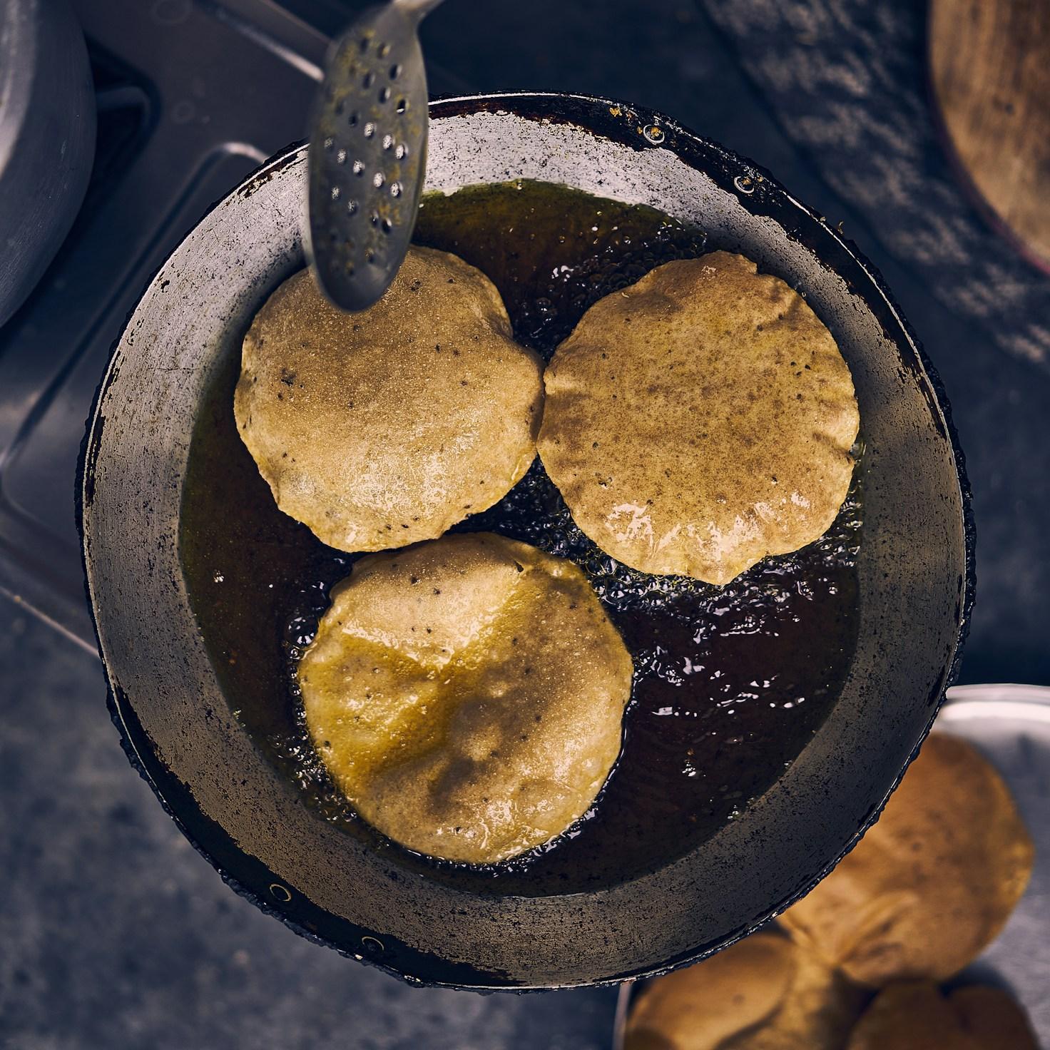 Diverse group of community members sharing a meal together, showcasing the social bonds formed through collaborative cooking